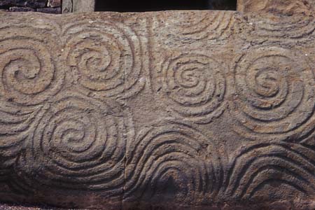 The entrance stone to the ancient megalithic temple of Newgrange which aligns to the winter solstice sunrise. It is covered in the symbol of the spiral, which is significant to the time of the winter solstice and used in this ceremony. (photo copyright 2006 wiki user Maksim)