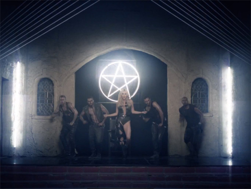 This snapshot from the music video 'Die Young' by pop singer Kesha is a good example of how symbols of light are demonized. The symbol hangs in an old church where Kesha engages in perverse acts.