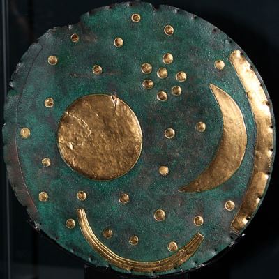 The Nebra Sky Disk. The outer gold rim on the right was also matched by one on the left, which is now missing. These marked the sunsets and sunrises of the winter and summer solstice. The moon and sun are represented in the middle, and are surrounded by stars, which are believed to represent a number of constellations, including possibly the Pleiades. (photo copyright wiki user Anagoria 17 August 2012)