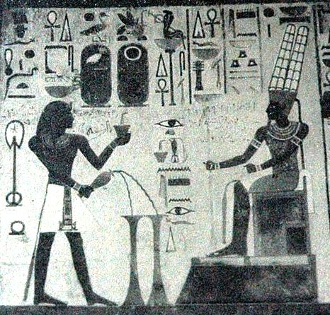 The creator god Amun being worshiped, seated with his feet raised above the level of the ground.
